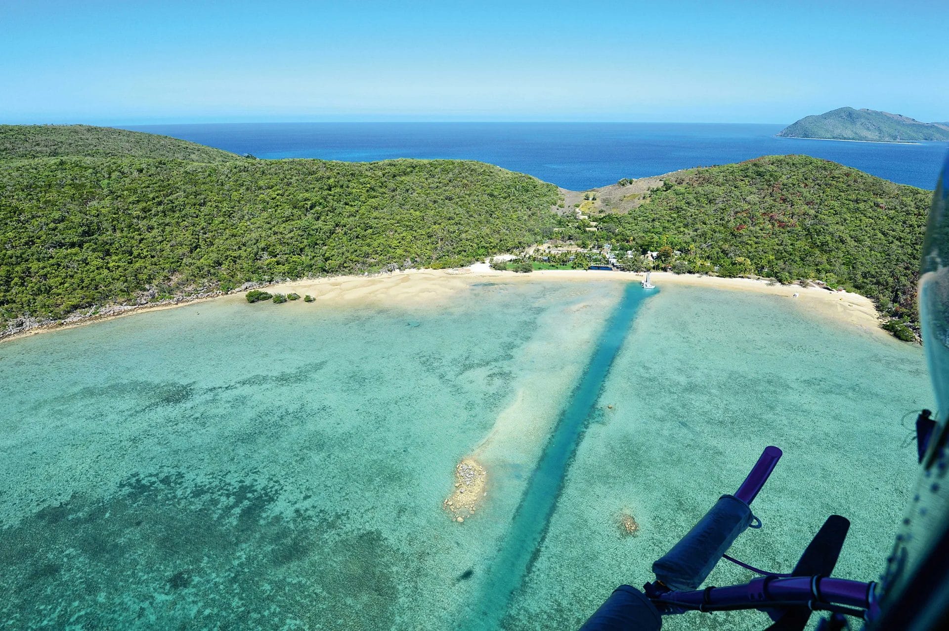 Aerial of Orpheus Island beach and ocean from helicopter.