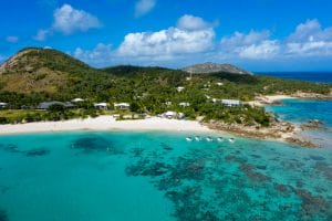 Overview of the Lizard Island complex and accommodation options with green forestry, white sand beaches, and turquoise waters