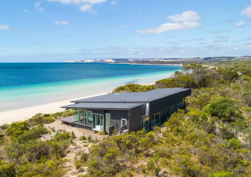 Exterior of private home One Kangaroo Island nestled amongst bush overlooking a white sand beach